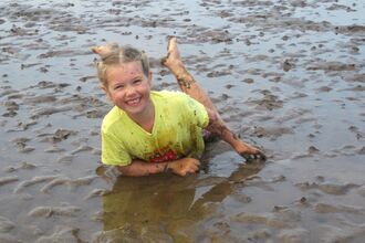 Child having fun in the mud © Kirsten Carter