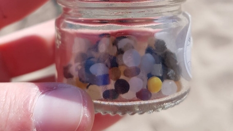 Nurdles in a jar on the beach