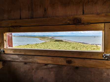 View over South Walney Nature Reserve from inside a bird hide