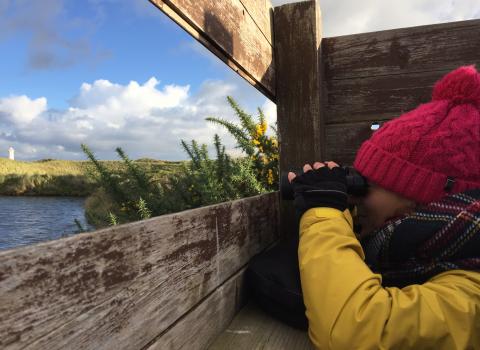People bird watching at South Walney Nature Reserve