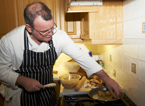 man frying seafood during wild oceans project